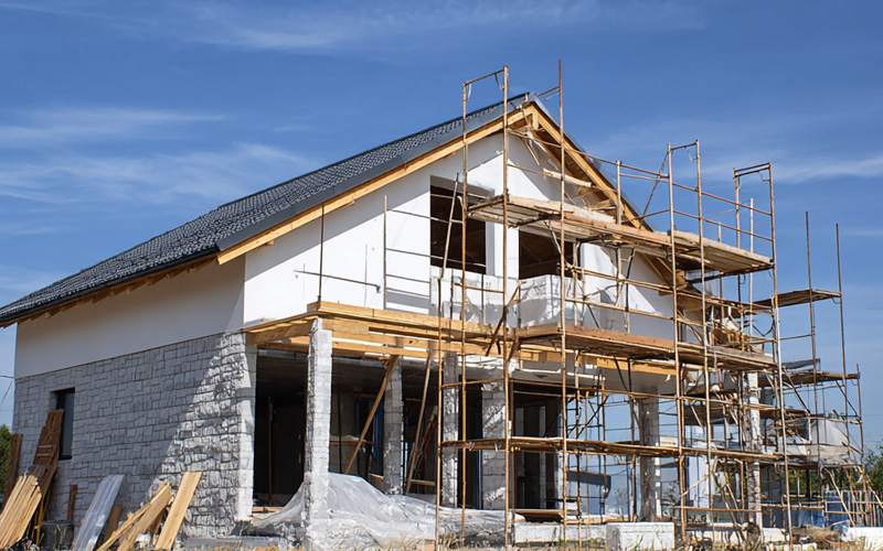 services_0006_Layer 2 Rendered two-storey house wrapped in scaffolding during construction